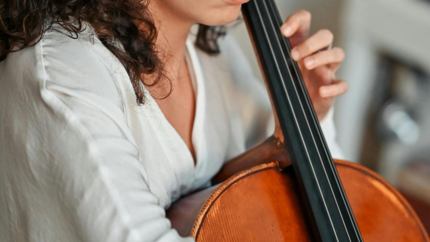 Woman learning how to play instrument during adult music lessons in Northern Virginia
