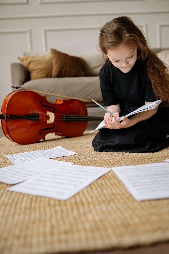 A child studying for their music classes near me